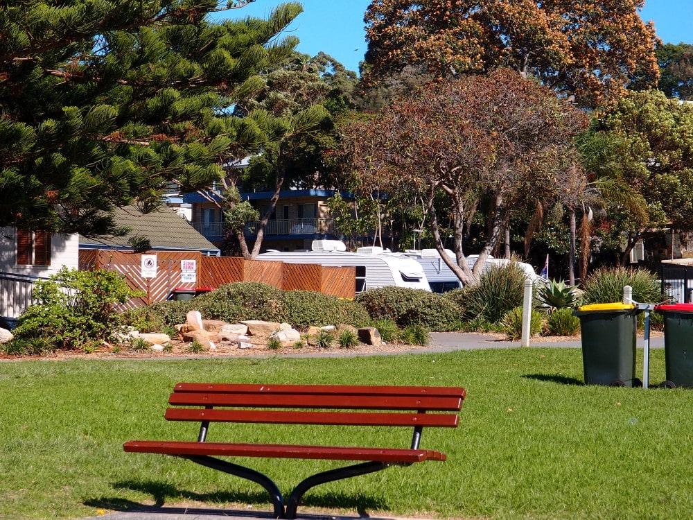 Kendalls Beach bench and holiday park cabins