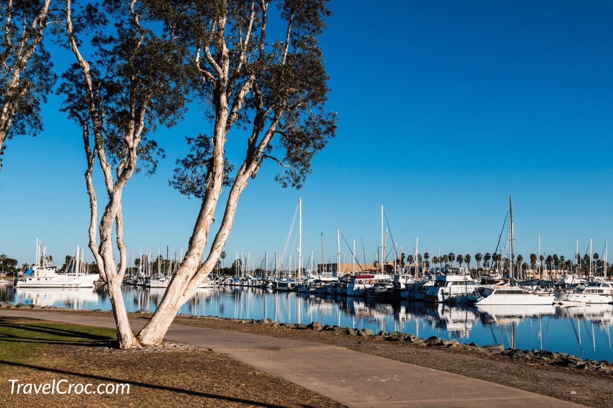 Pathway through the Chula Vista Bayfront park with boats moored in the marina.