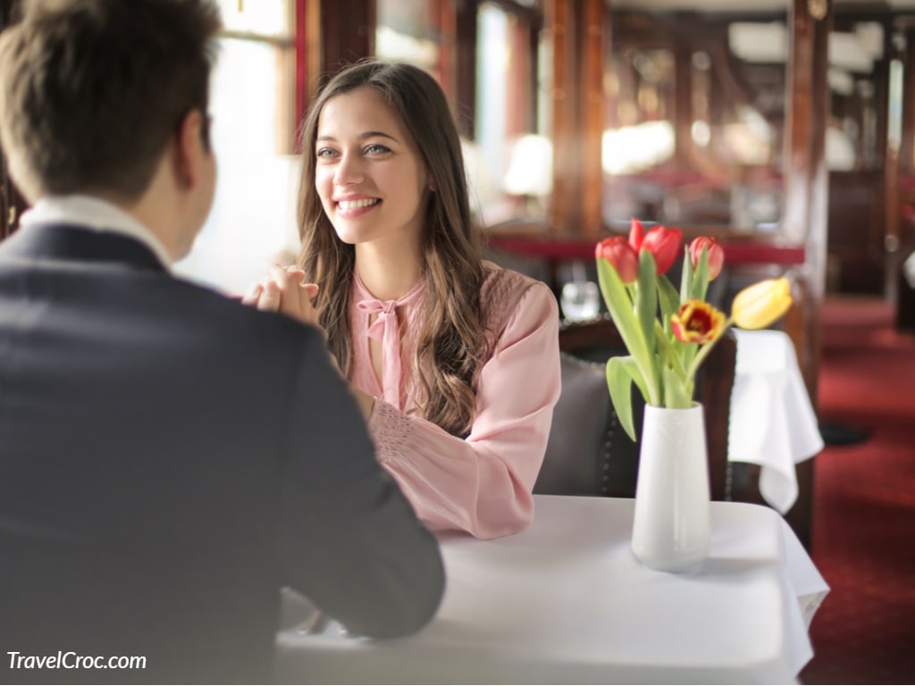 Sweet couple having a romantic dinner in a vintage train