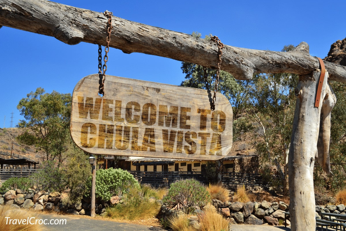 old vintage wood signboard with text welcome to Chula Vista hanging on a branch