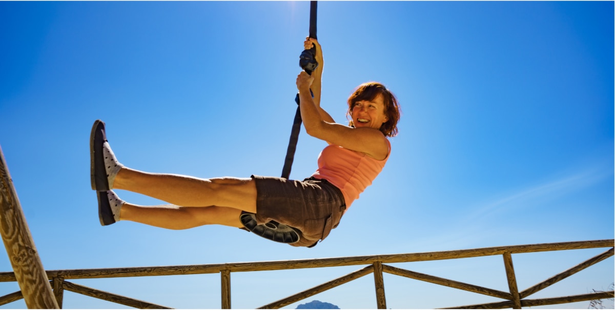Woman hanging on a zipline 