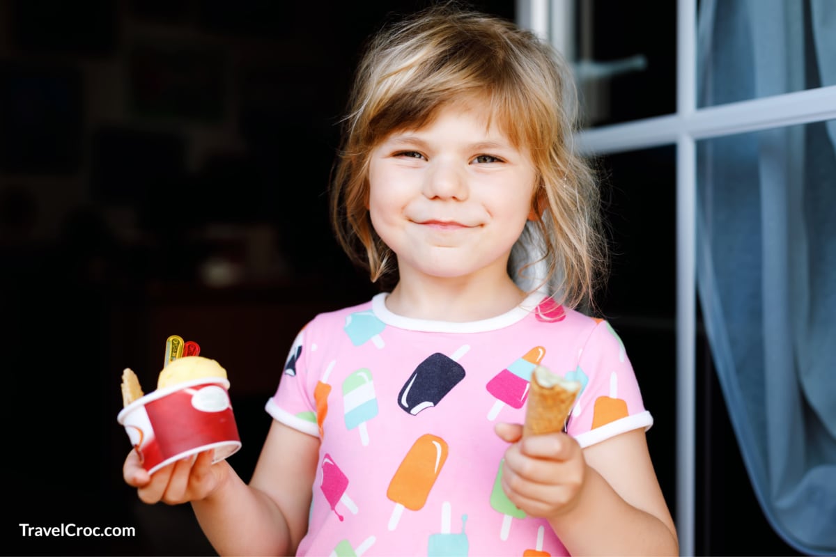 Girl eating ice-cream from ice-cream shop.