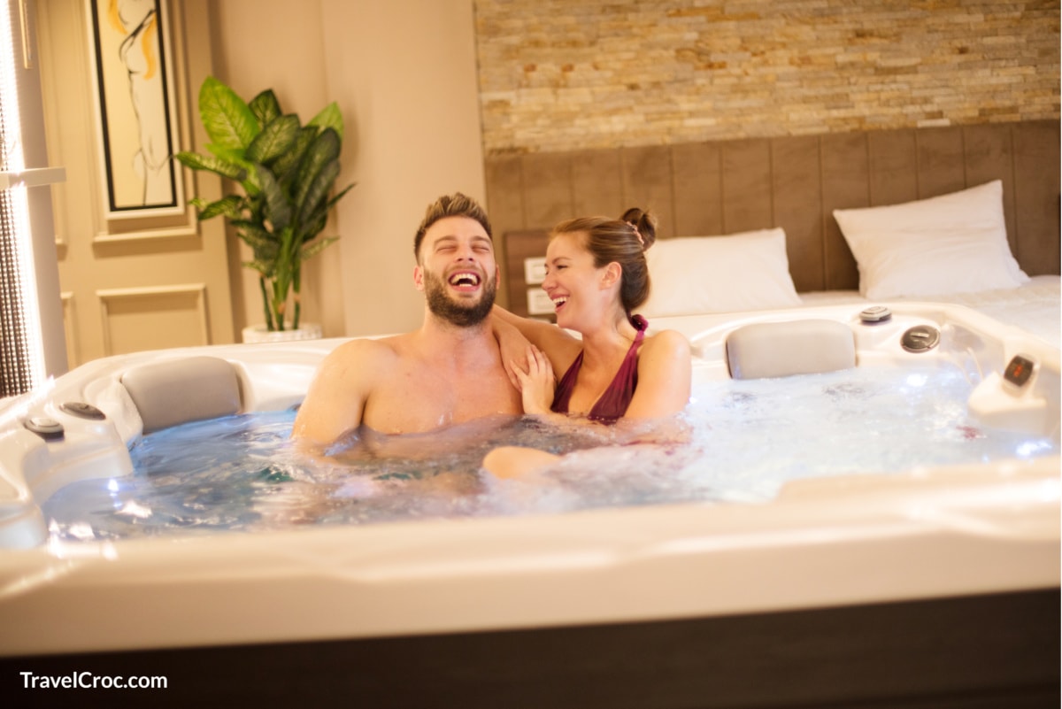 Couple enjoying hotel room with hot tub in Indianapolis.