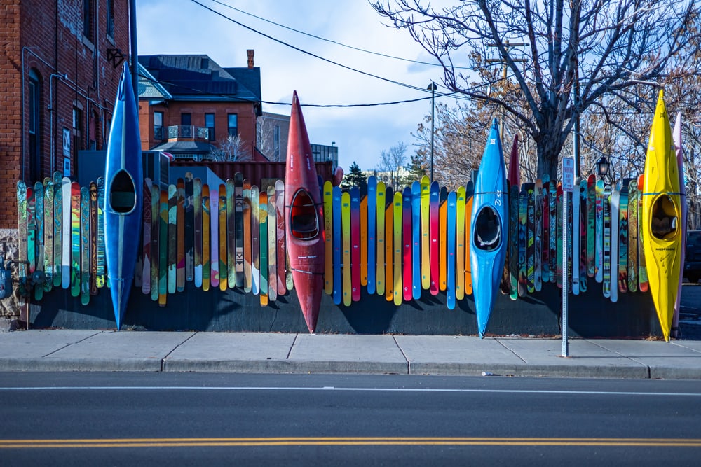 Denver, Colorado, USA - Wall decorated with colorful kayaks and water skis in downtown Denver. As seen directly across the street from the Denver Aquarium.
