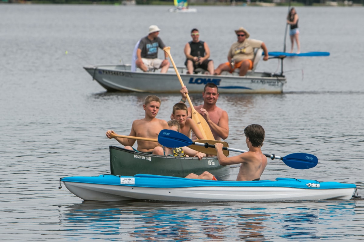 Pocono Lake, Pennsylvania, July 3, 2016 People are enjoying their playful mood as they are boating near a lake shore during a hot summer day.