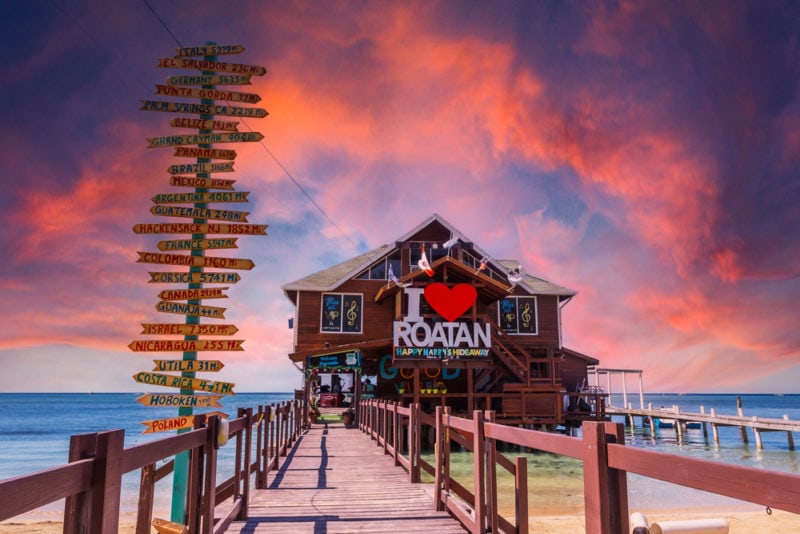 Roatán, Honduras a wooden bar over the sea at West End Beach on the island of Roatan at sunset