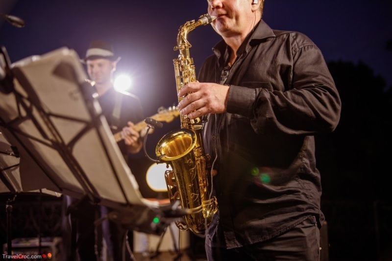 Saxophone player playing in orchestra at night outdoor concert - What to do in Idaho
