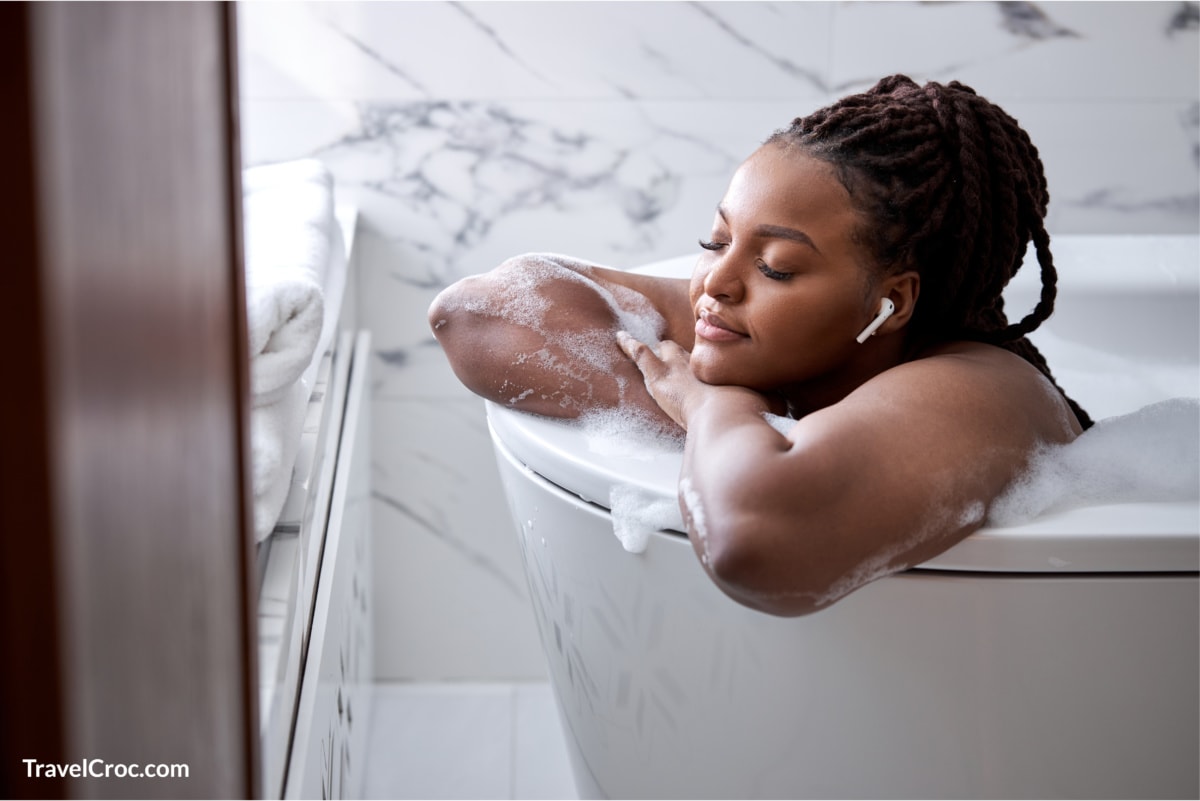 Woman relaxing in hotel luxury bathtub