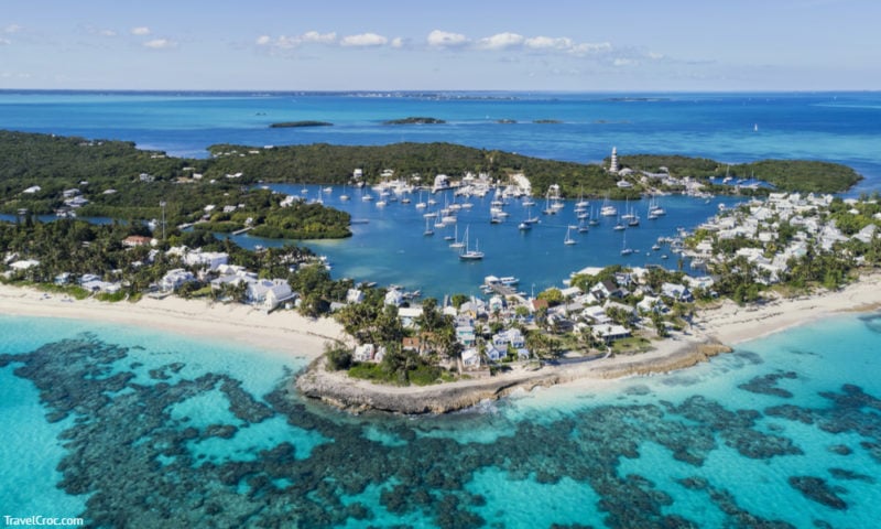 Aerial view of the harbour, beach and lighthouse in Hope Town on Elbow Cay off the island of Abaco, Bahamas.