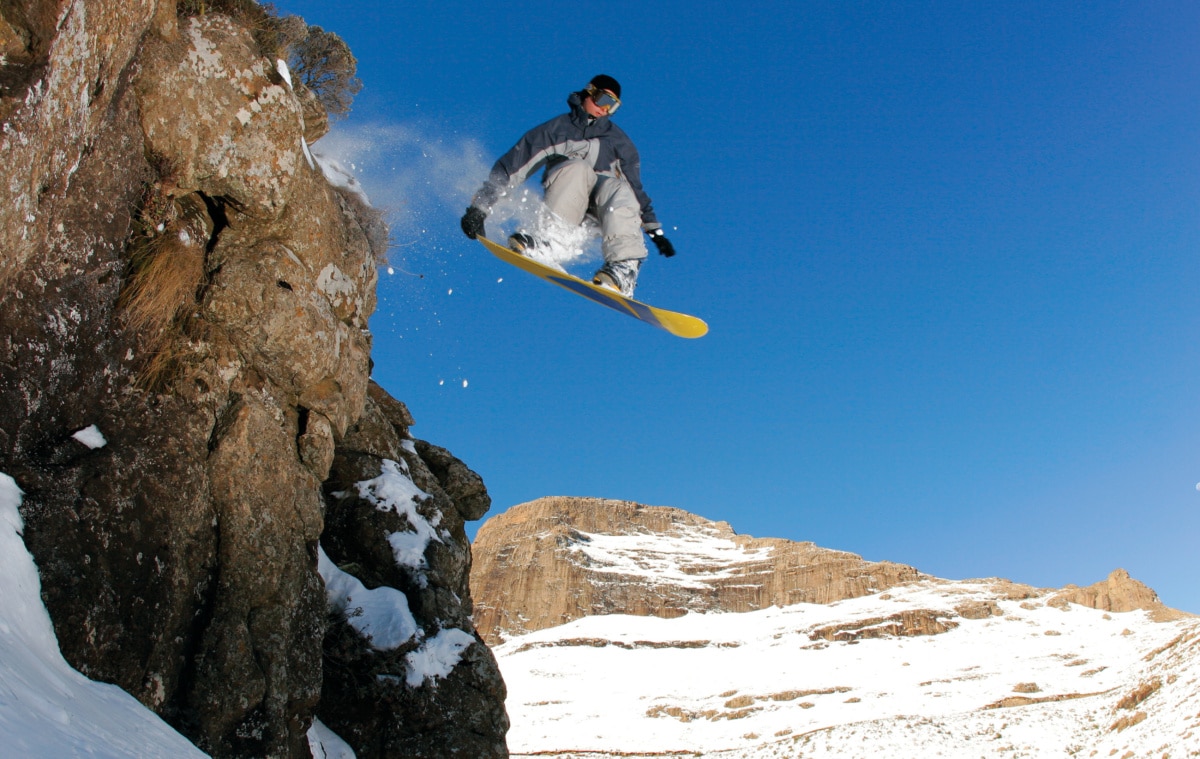 MALUTI MOUNTAINS, LESOTHO 2 JULY 2014 A snowboarder jumps off a cliff in rural Lesotho