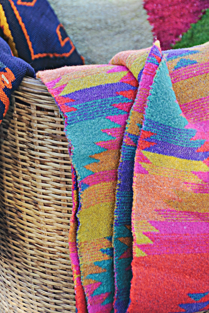 textiles and blankets in a wicker basket