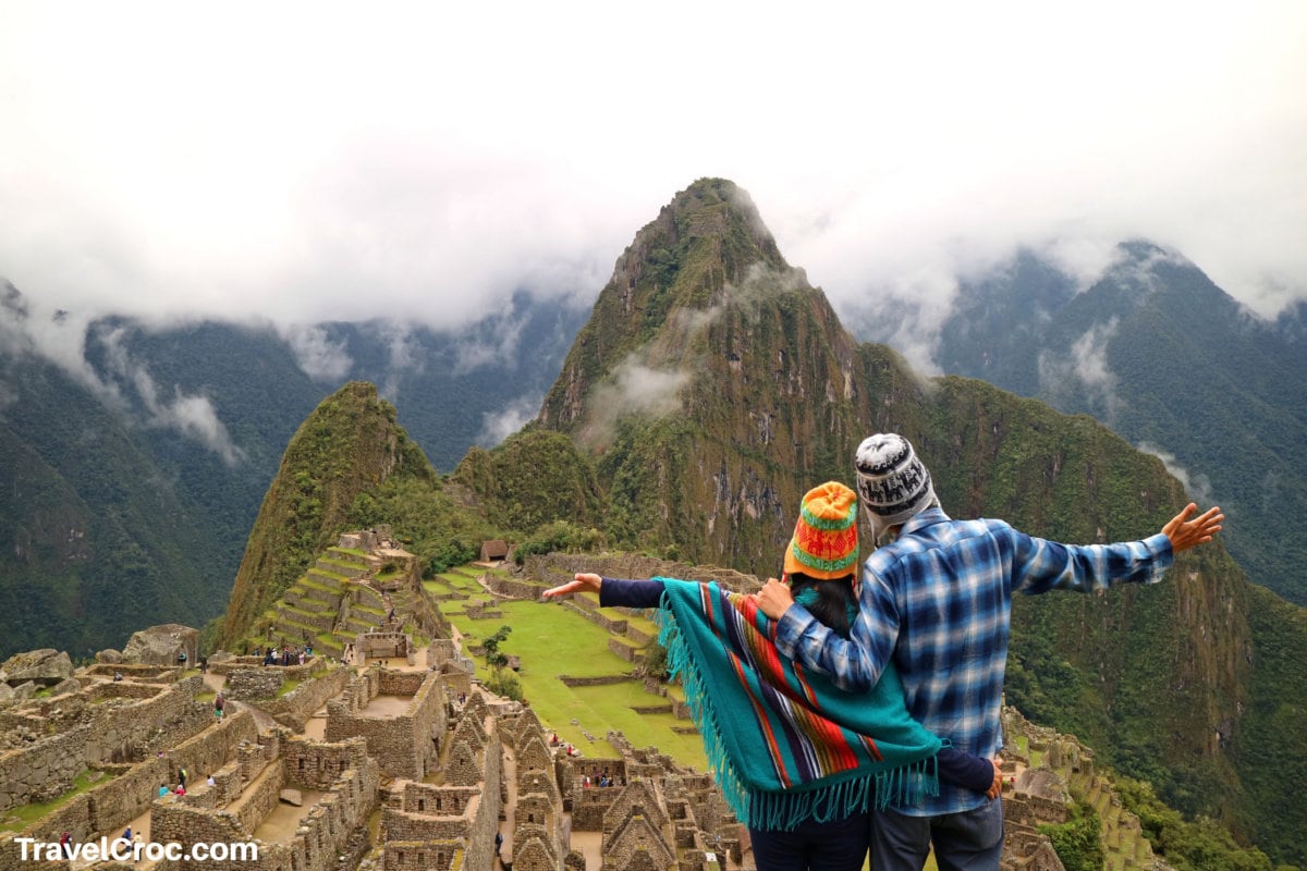 Couple admiring the spectacular view of Machu Picchu