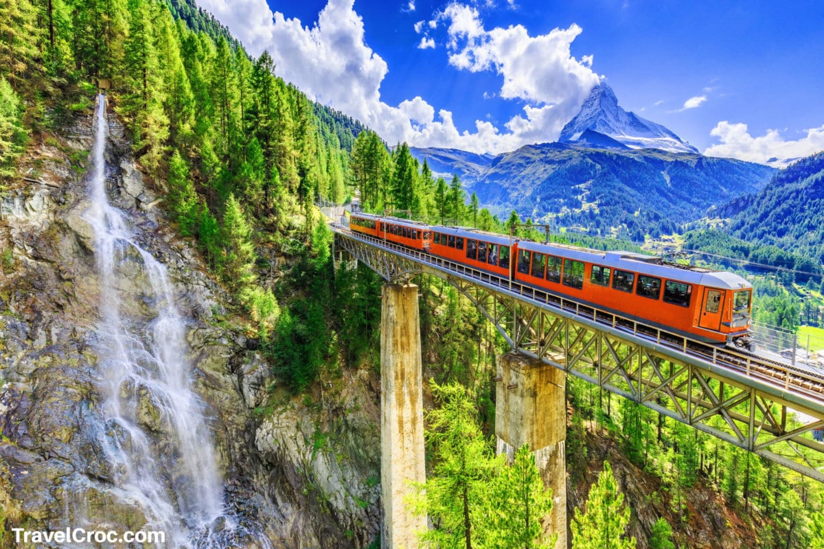 Zermatt, Switzerland. Gornergrat tourist train with waterfall, bridge and Matterhorn.