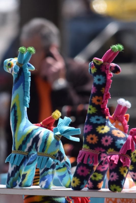 Flea Market, San Francisco, featuring colorful stuffed giraffes.