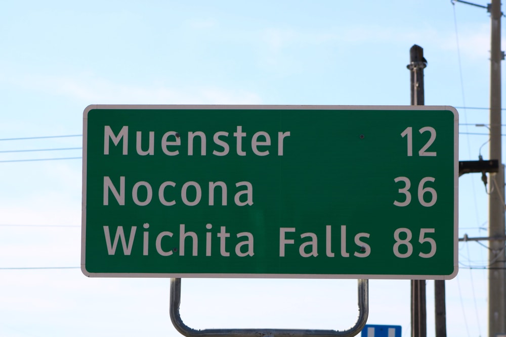 Highway sign for Muenster, TX