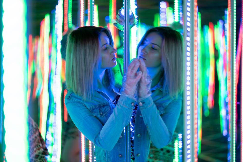 Female looking at herself in mirror maze